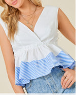 White v-neck top with blue ruffle