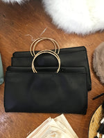 Black folding clutch with gold hoop straps